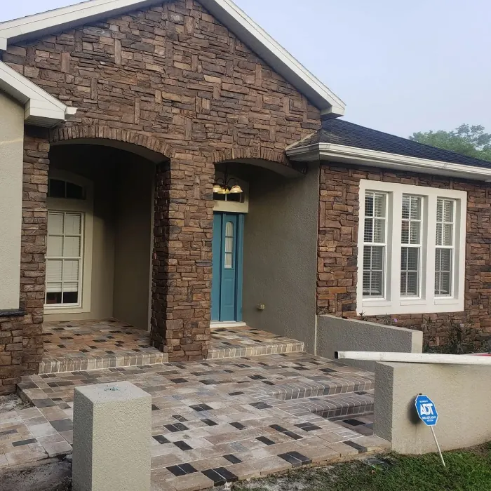 Paver front entry landing on a brick home