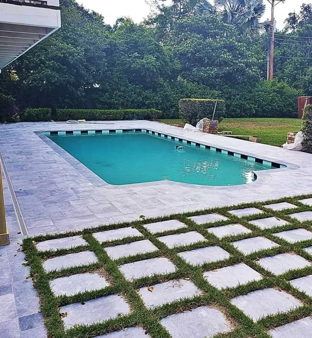 Pool deck with large pavers set in turf joints