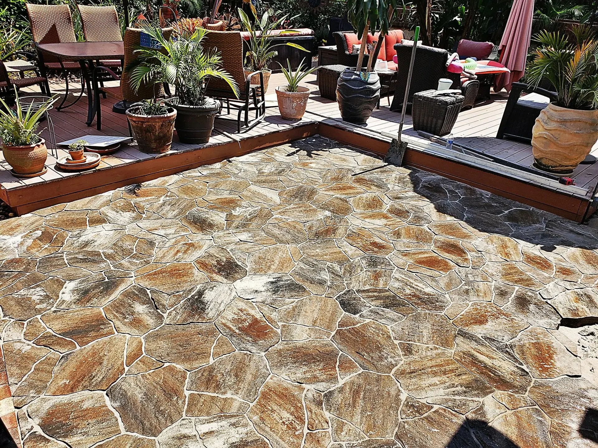 Natural stone-look patio with outdoor furniture